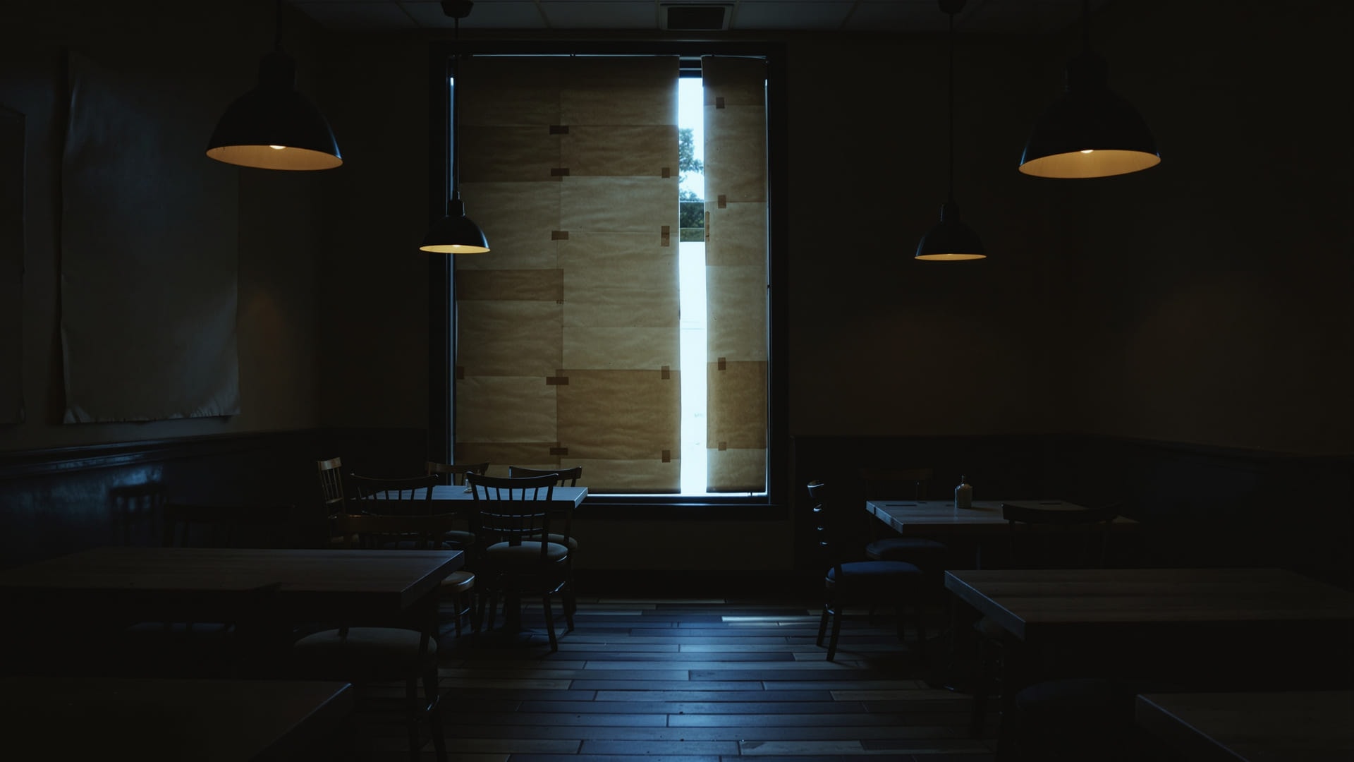 Chairs stacked on tables in a closed restaurant dining room